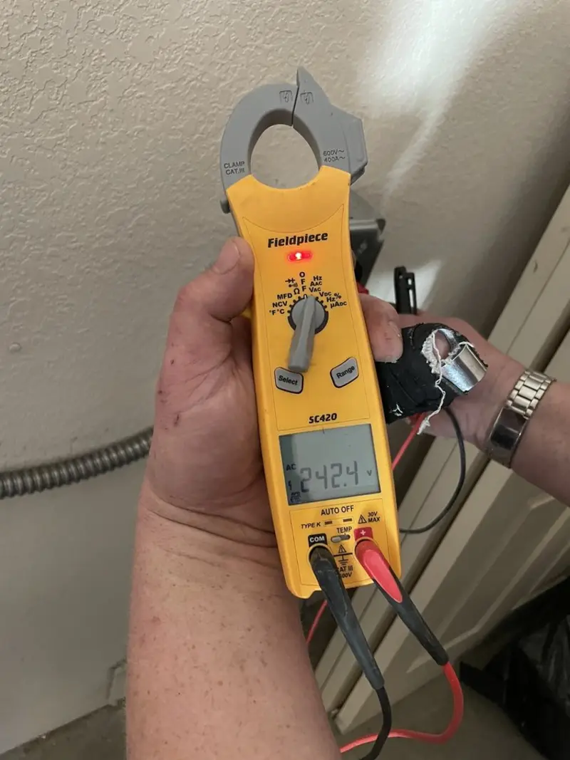 Voltage testing with clamp meter during Outlet Installation in Cinco Ranch